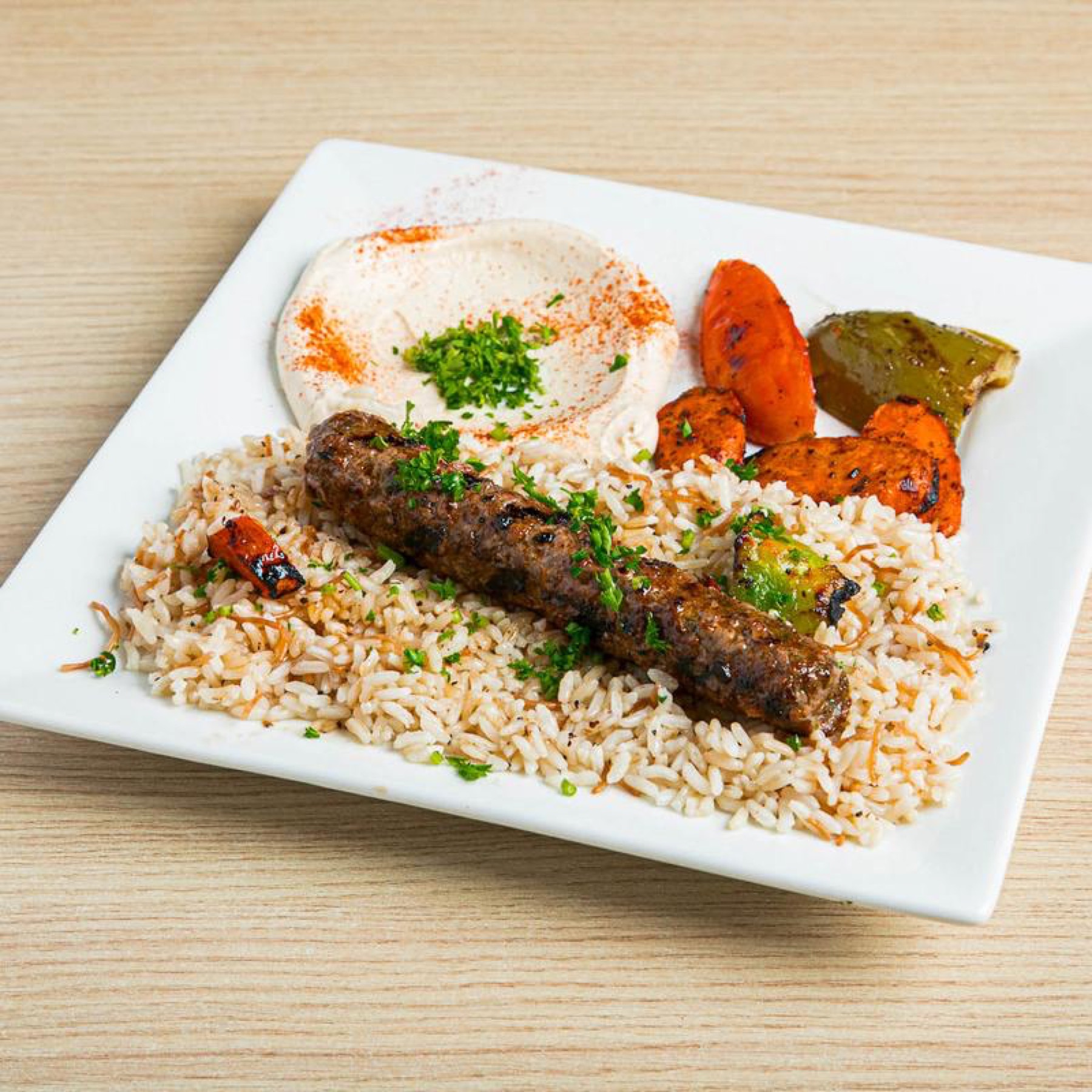 Shish kafta skewer over rice